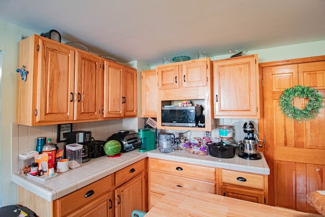 kitchen with backsplash and tile counters