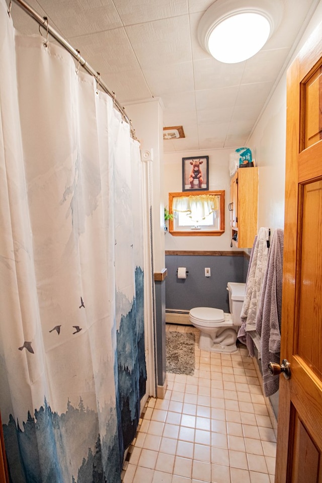 bathroom featuring tile patterned flooring, a baseboard radiator, and toilet