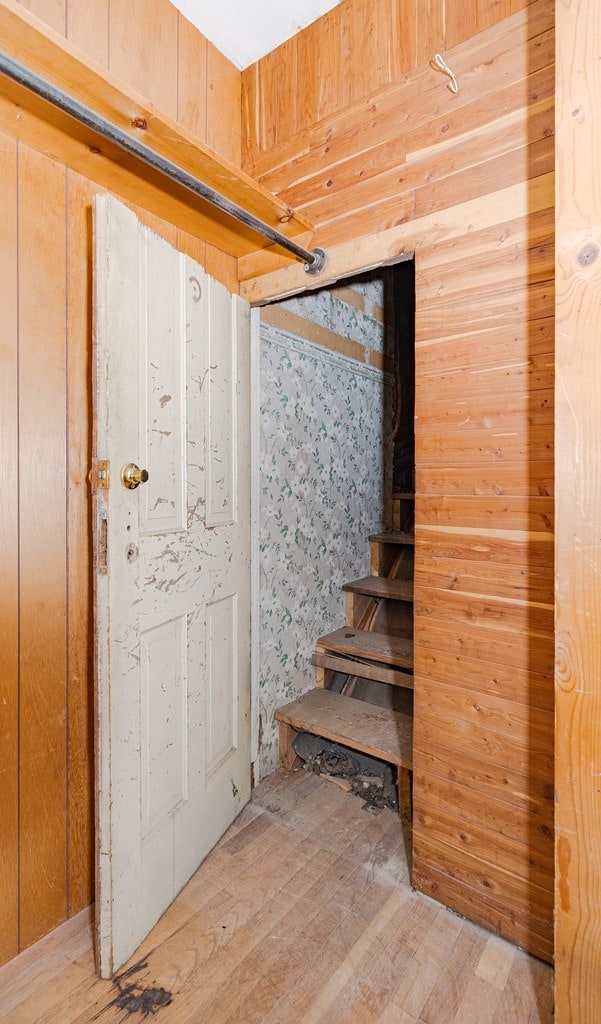 stairway with wood walls