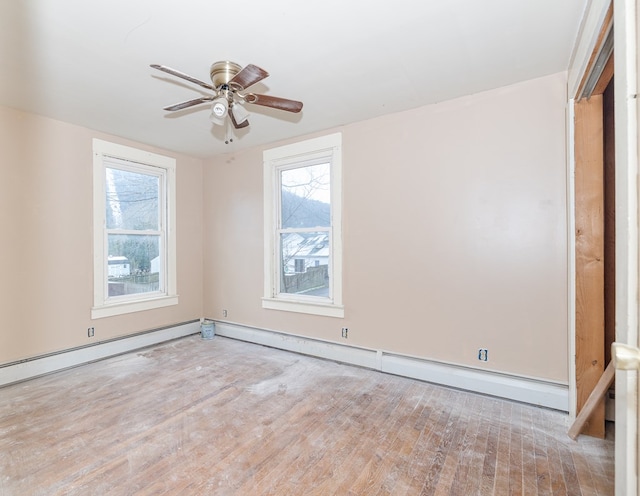 spare room featuring ceiling fan, light hardwood / wood-style flooring, and a baseboard radiator