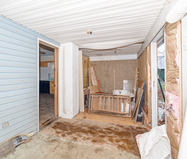 misc room featuring wooden walls