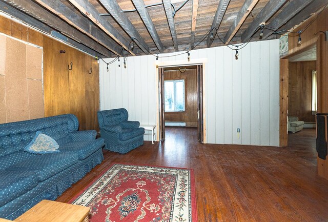 living room featuring wood walls and dark wood-type flooring