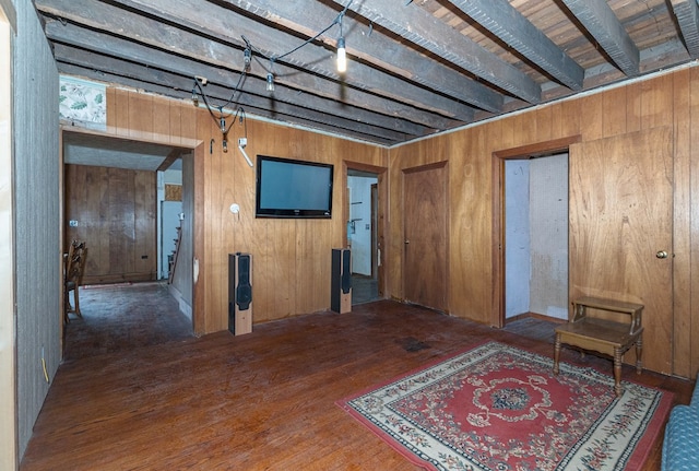 misc room featuring dark hardwood / wood-style floors and wooden walls