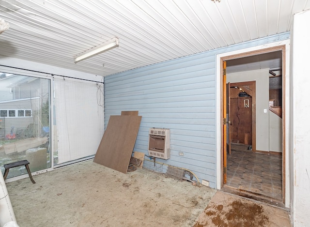 interior space with heating unit and wood walls