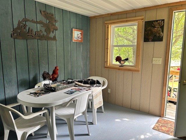 dining room featuring wood walls