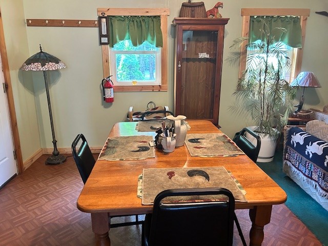 dining space with parquet floors