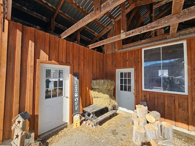 interior space with wood walls and high vaulted ceiling