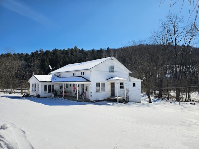 view of front of house featuring a wooded view