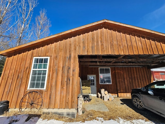 view of side of property featuring an outbuilding and board and batten siding