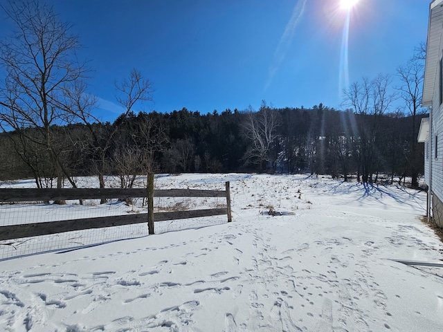 yard covered in snow with fence