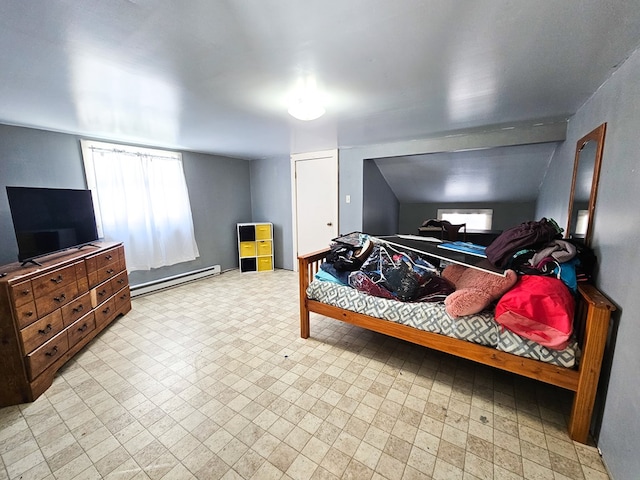 bedroom with a baseboard heating unit and light floors