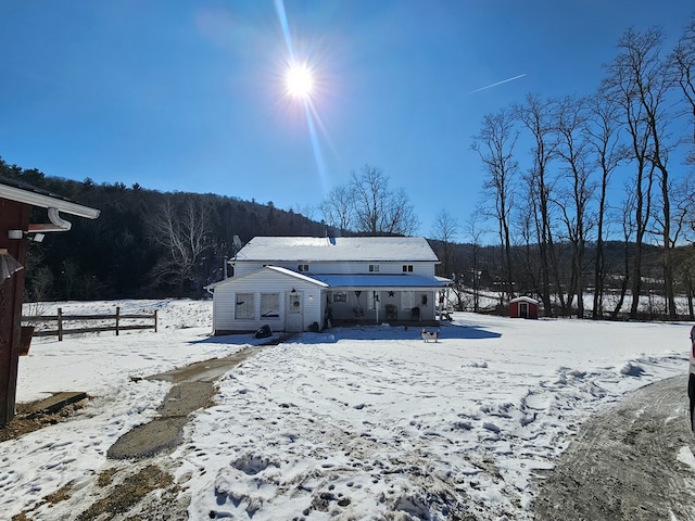 view of snow covered rear of property