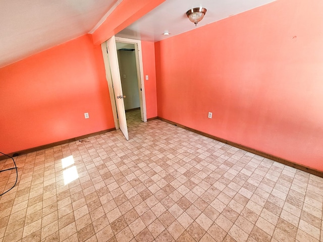 bonus room featuring vaulted ceiling and baseboards