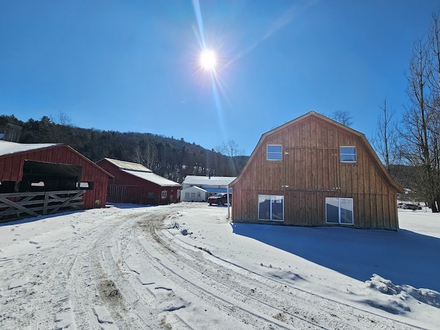 view of street featuring driveway and a barn