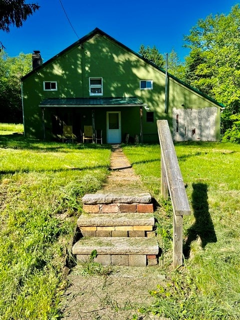 back of property with a lawn