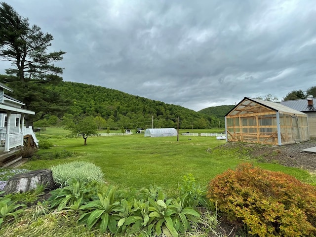 1571 State Route 44n, Coudersport, PA 16915 - view of yard featuring a greenhouse, an outbuilding, a view of trees, and a mountain view
