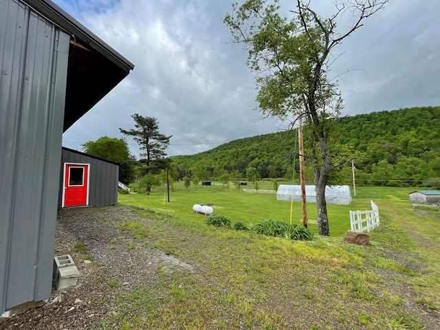 1571 State Route 44n, Coudersport, PA 16915 - view of grassy yard with a forest view, an outdoor structure, and a mountain view