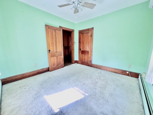 unfurnished bedroom with carpet floors, ceiling fan, and a baseboard heating unit