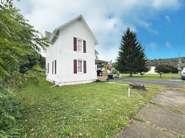 view of property exterior with a lawn