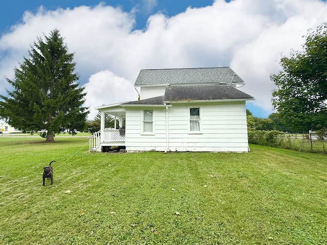 view of side of property with a lawn