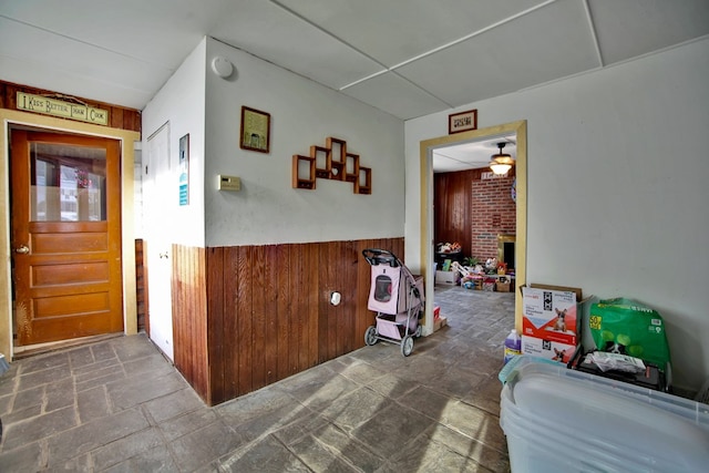 interior space featuring ceiling fan and a fireplace