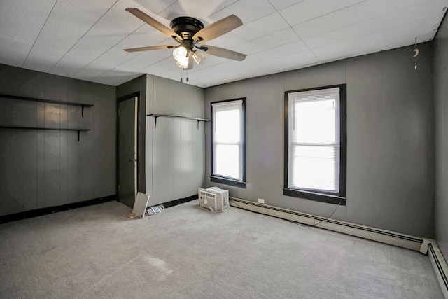 unfurnished bedroom with light carpet, ceiling fan, and a baseboard radiator