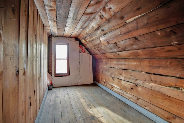 bonus room with light hardwood / wood-style floors, wooden ceiling, and vaulted ceiling