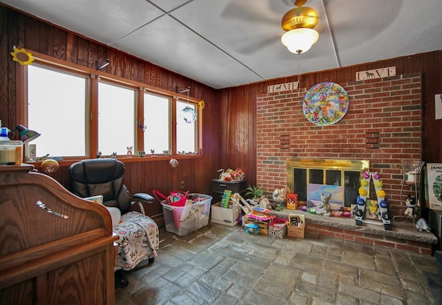 interior space with a fireplace and wood walls