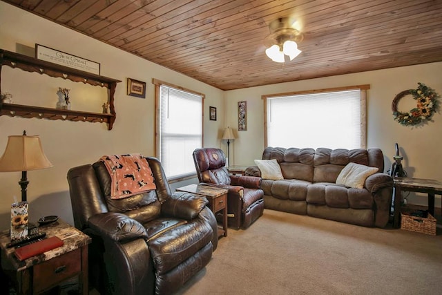 carpeted living room featuring ceiling fan and wood ceiling