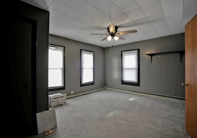 unfurnished room featuring ceiling fan, light colored carpet, plenty of natural light, and a wall mounted AC