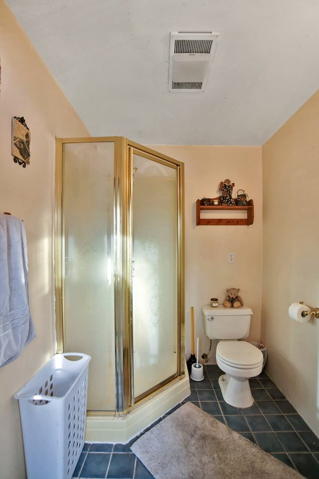 bathroom featuring walk in shower, tile patterned floors, and toilet