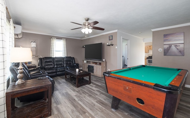 rec room with a wall unit AC, ornamental molding, wood finished floors, billiards, and a ceiling fan