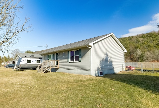 view of front of house with a front yard and fence