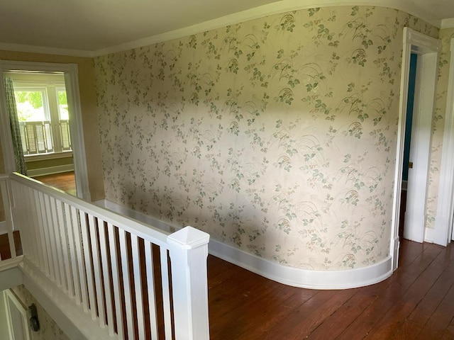 corridor featuring wood-type flooring and ornamental molding