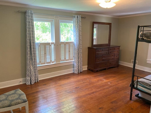 bedroom with dark wood-type flooring and ornamental molding