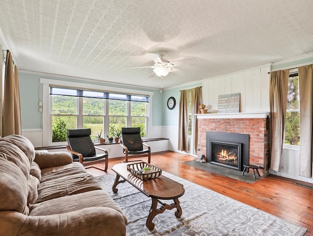 17800 Rte 6, Towanda, PA 18848 - living room with hardwood / wood-style flooring, a wainscoted wall, ornamental molding, ceiling fan, and a fireplace