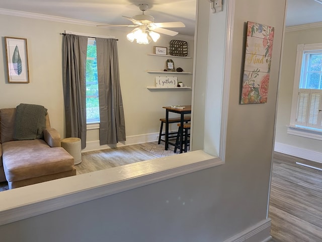 sitting room featuring ceiling fan, crown molding, and hardwood / wood-style floors