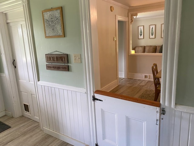 bathroom featuring wood-type flooring and ornamental molding