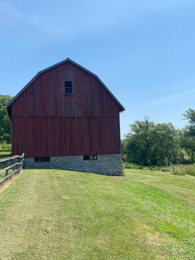 view of outbuilding featuring a yard