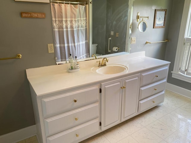 bathroom featuring toilet and vanity