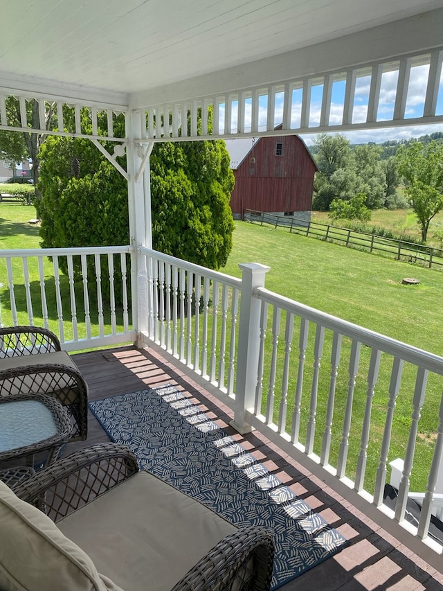 deck featuring a yard and a storage unit