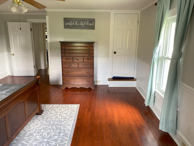 bedroom featuring ceiling fan, dark hardwood / wood-style floors, and ornamental molding