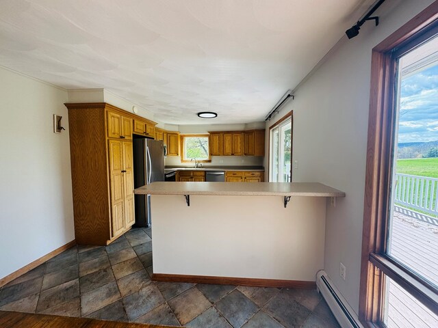 425 Gateway Industrial Park Rd, Athens, PA 18810 - kitchen featuring a peninsula, stainless steel appliances, baseboards, and brown cabinetry