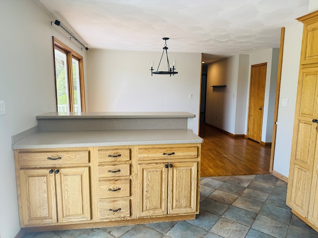 425 Gateway Industrial Park Rd, Athens, PA 18810 - kitchen with a peninsula, stone finish floor, baseboards, decorative light fixtures, and light countertops