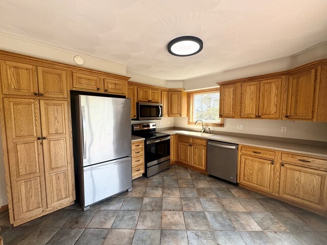 425 Gateway Industrial Park Rd, Athens, PA 18810 - kitchen featuring stone finish floor, stainless steel appliances, a sink, and brown cabinets