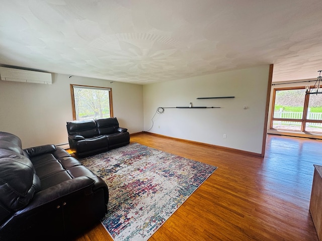 425 Gateway Industrial Park Rd, Athens, PA 18810 - living area featuring baseboards, wood finished floors, a baseboard radiator, and a wall unit AC