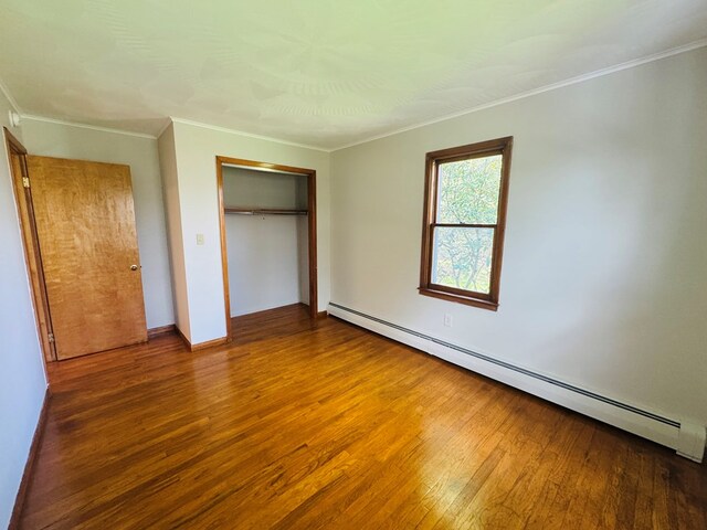 425 Gateway Industrial Park Rd, Athens, PA 18810 - unfurnished bedroom featuring crown molding, wood-type flooring, a closet, and baseboard heating