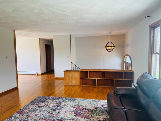 425 Gateway Industrial Park Rd, Athens, PA 18810 - living area featuring baseboards, wood finished floors, a baseboard radiator, and a notable chandelier