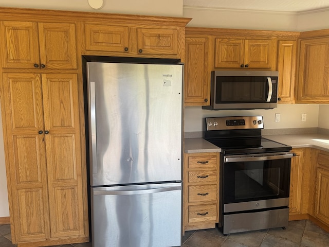 425 Gateway Industrial Park Rd, Athens, PA 18810 - kitchen with light countertops, stainless steel appliances, tile patterned flooring, and brown cabinetry