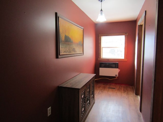 hallway featuring light hardwood / wood-style flooring and heating unit